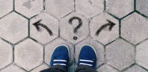 choices image shoes in front of a question mark and arrows in opposite direction choosing a will versus a trust kelley way estate planning lawyer walnut creek california Should I Put My Copyrights in a Trust or LLC