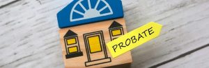 toy wooden house with a sticky note on it that says probate for article estate plan basics part 2 estate planning steps