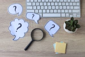 question marks on a desk for the article by kelley way titled Frequently Asked Questions in Estate Planning