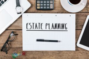 estate planning written on paper on top of a desk for article on common estate planning mistakes by kelley way