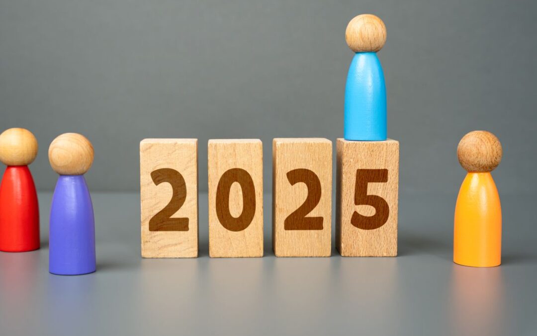 wood tiles spell out the year 2025 with wooden peg people surrounding the numbers with a gray background which is the featured image for the blog post titled kelley way's top blog posts of 2025