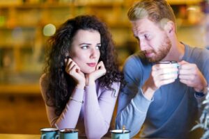 young attactive couple looking worried while drinking coffee is featured image for blog post by kelley a way titled 5 Reasons Why Making a Will Can Be So Hard
